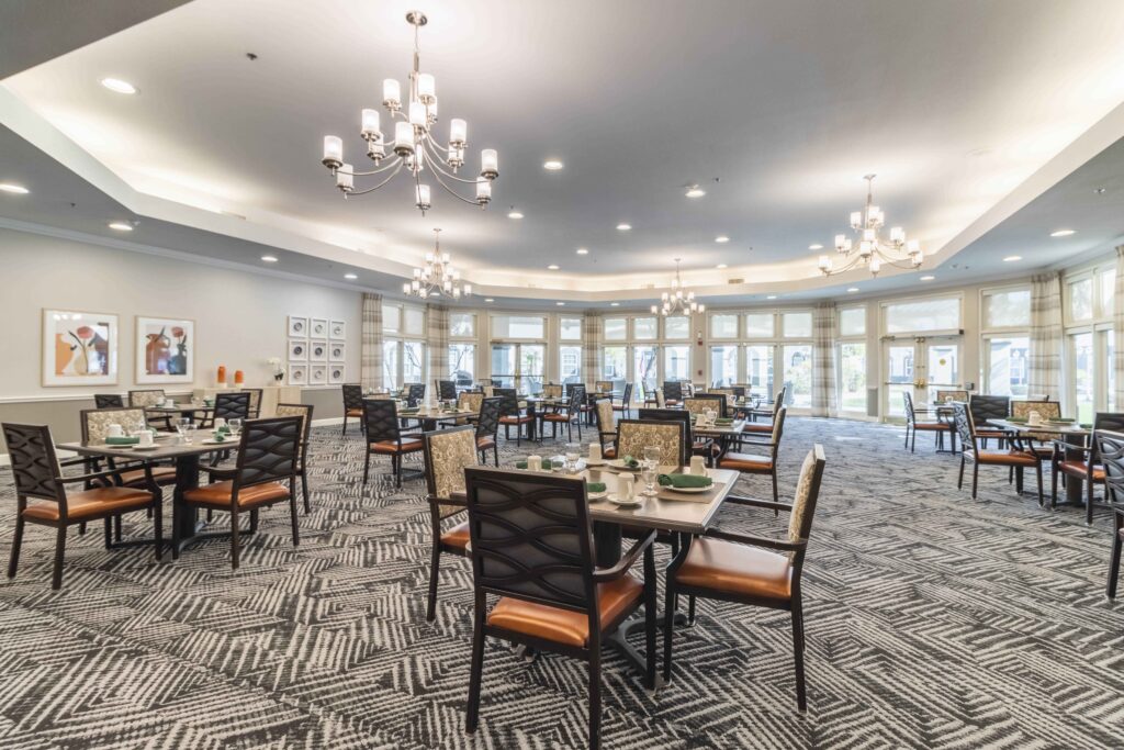 Interior photograph of the Inspirations of Tempe facility dining room. The room is decorated and well lit, with a luxurious feel.
